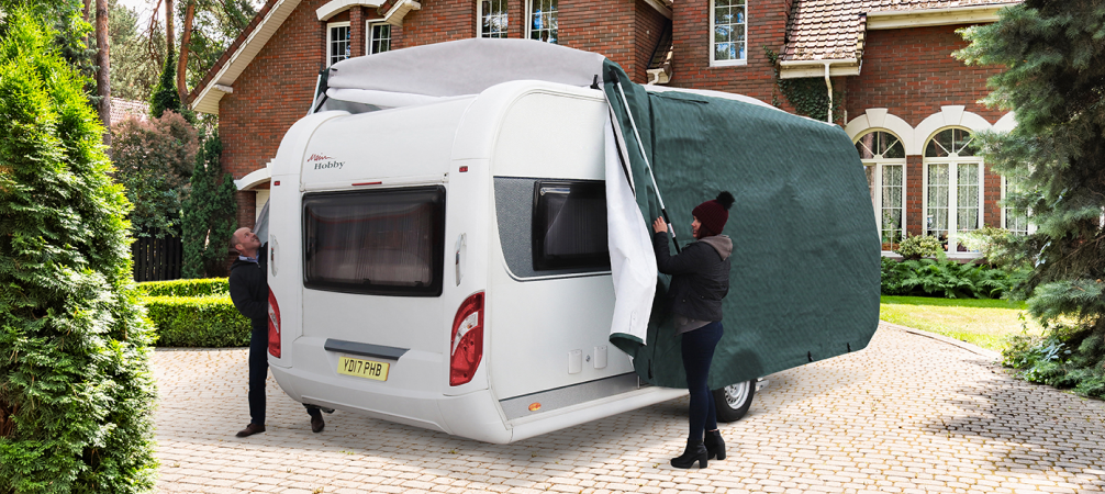 Green Caravan with cover on courtyard